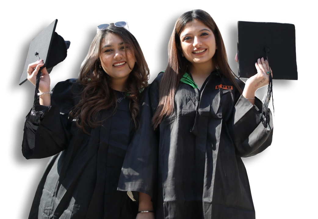 Two graduating students in academic gowns holding their caps